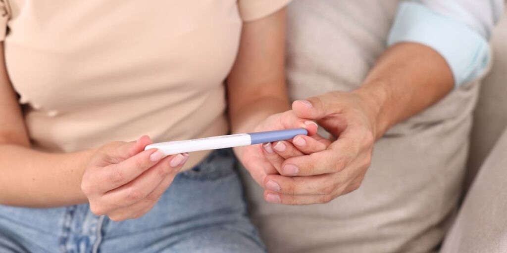 Pregnancy test kit hold by couple